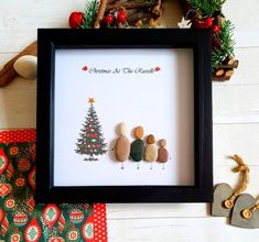 some rocks are sitting in front of a christmas tree