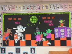 a bulletin board with cartoon characters on it in a school classroom setting that is decorated for halloween