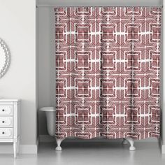 a red and white shower curtain in a bathroom