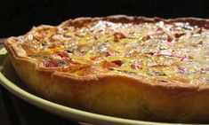 a quiche is sitting on a yellow plate