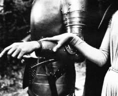 a man and woman dressed in medieval armor