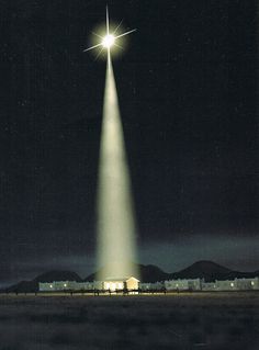 an image of a very tall star in the sky with people walking around it at night