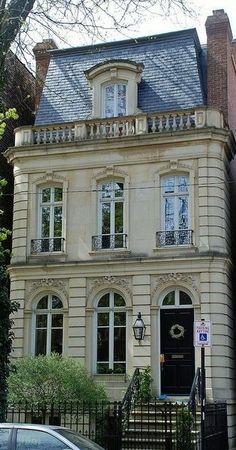 a car parked in front of a large house