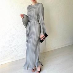 This maxi dress encapsulates timeless elegance with a contemporary twist. The pleated bell sleeves add a touch of drama and sophistication to the overall look, making it perfect for various occasions. The flowing fabric drapes gracefully, ensuring you move with ease and confidence. The pleats not only enhance the aesthetic appeal but also provide a flattering silhouette, making this dress suitable for all body types. Details Material: PolyesterFit Type: Regular FitThickness: RegularElastic: No StretchStyle: Elegant,CasualDesign: Pleated, Belt,Bell SleevesOccasion: Daily, Date Night Size Chart /cm : Grunge Style Outfits, Long Dresses Elegant, Drape Maxi Dress, Banquet Dresses, Flare Sleeve Dress, Dress Sleeve Styles, Long Sleeve Casual Dress, فستان سهرة, Loose Outfit