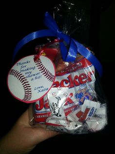 a person holding a bag of baseball candy