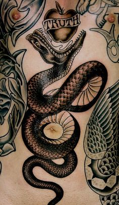 an image of a snake tattoo on the back of a man