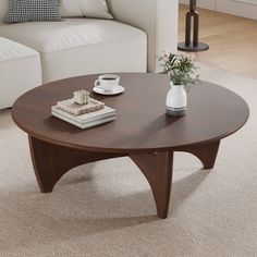 a coffee table sitting on top of a carpeted floor next to a white couch