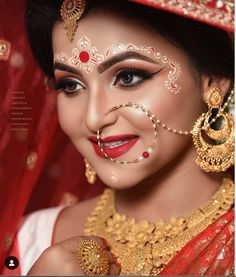 a woman with makeup and jewelry on her face