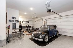 a car is parked in the garage next to some stools