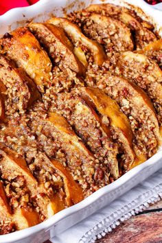 a casserole dish filled with apples and pecans