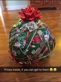 a christmas ball wrapped in wrapping on top of a wooden floor