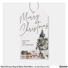 a christmas gift tag with the words merry christmas and a dog near a christmas tree