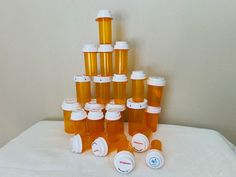 there are many prescription bottles stacked on top of each other in order to be filled with them