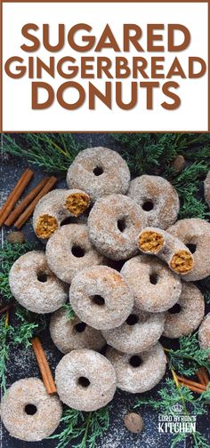 a pile of sugared gingerbread donuts next to cinnamon sticks