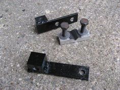 two pieces of metal sit on the ground next to each other, with one piece missing