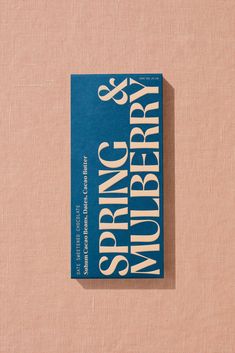 a book that is sitting on top of a pink surface with the words spring and spring written in white