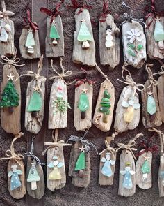 christmas ornaments are hanging on wooden planks and tied with twine string, along with other decorations