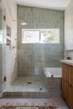 a bathroom with a bathtub, shower and rug in the middle of the room