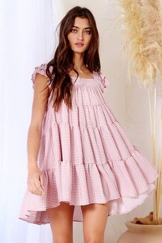 Our Penelope Gingham Print Tiered Babydoll Mini Dress is perfect for those hot summer days. It has a square neck and back, is pleated to give a flattering shape and features a tiered silhouette making it flowy while not looking misshapen! Gingham Tiered Dress, Cute Tiered Dress For Garden Party, Cute Square Neck Mini Dress For Beach, Tiered Ruffle Hem Dress For Picnic, Beach Sundress With Ruffle Hem And Square Neck, Spring Vacation Tiered Dress With Square Neck, Beach Sundress With Square Neck And Ruffle Hem, Square Neck Dress With Ruffle Hem For Picnic, Casual Square Neck Sundress For Picnic