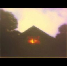 a blurry image of a house with two eyes