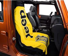 an orange jeep with a yellow seat cover on it's back door and the word speed written in black