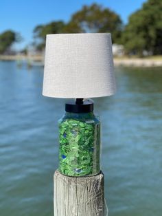 a lamp sitting on top of a wooden post