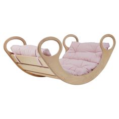 a child's rocking chair with pink cushions and two circular wheels on the back