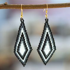 Handcrafted by artisan Angeles Gonzalez from Mexico, these gorgeous diamond-shaped dangle earrings are perfect to complement any outfit. Angeles places each glass bead meticulously to form a black and white geometric pattern that embellishes these graceful earrings with 14k gold-plated hooks. Black Diamond-shaped Jewelry For Gift, Black And White Geometric Pattern, Buy Bead, Beaded Dangle Earrings, Diamond Shaped, Beaded Dangles, Hook Earrings, Glass Bead, Diamond Shapes