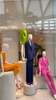 three mannequins dressed in bright colored clothing