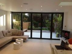 a living room filled with furniture next to a sliding glass door