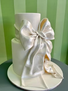 a white wedding cake with a large bow on top