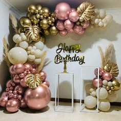 a birthday party with balloons and decorations in pink, gold and white colors on the wall