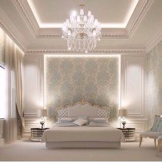 an elegant bedroom with chandelier and white furniture