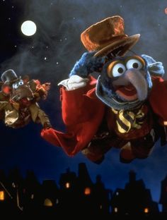 the muppet is flying through the air with his hat on and other characters around him