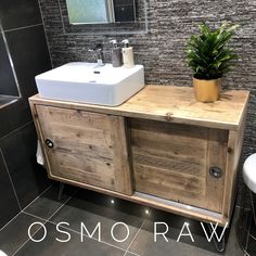 a bathroom with a sink, mirror and wooden cabinet