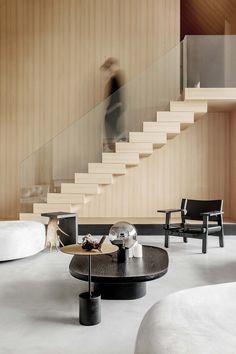 a living room filled with furniture next to a stair case