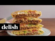 three sandwiches stacked on top of each other with the words delish in front of them