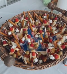 a basket filled with lots of food on top of a white tablecloth covered floor