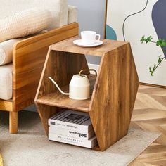 a wooden shelf with a teapot and coffee pot on it next to a couch