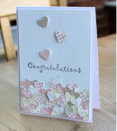 a card with hearts and congratulations written on it