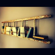 an old wooden shelf with books on it