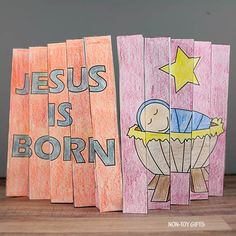 three handmade wooden cards with the words jesus is born and a baby in a crib