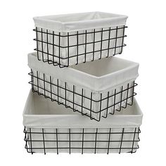 three white baskets are stacked on top of each other