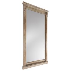 a wooden mirror sitting on top of a white wall