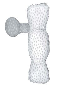 a white and gray teddy bear pillow with hearts on it's back, sitting upright