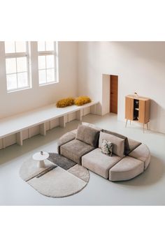 a living room with a couch and rugs on the floor