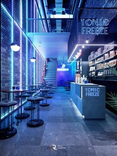 the interior of a restaurant with blue lighting and stools in front of it's counter