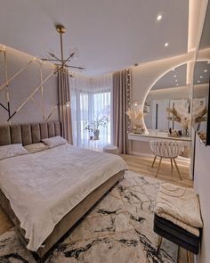 a large bed sitting in the middle of a bedroom next to a mirror and table