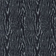 a black and white background with an animal print pattern on the fabric, it is very dark