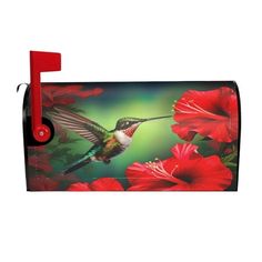 a mailbox with a painting of a hummingbird and red flowers on the front